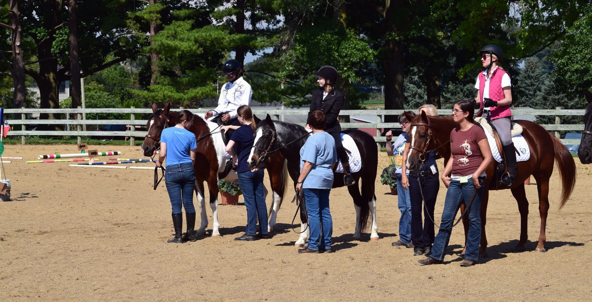 horses and riders outside on the range