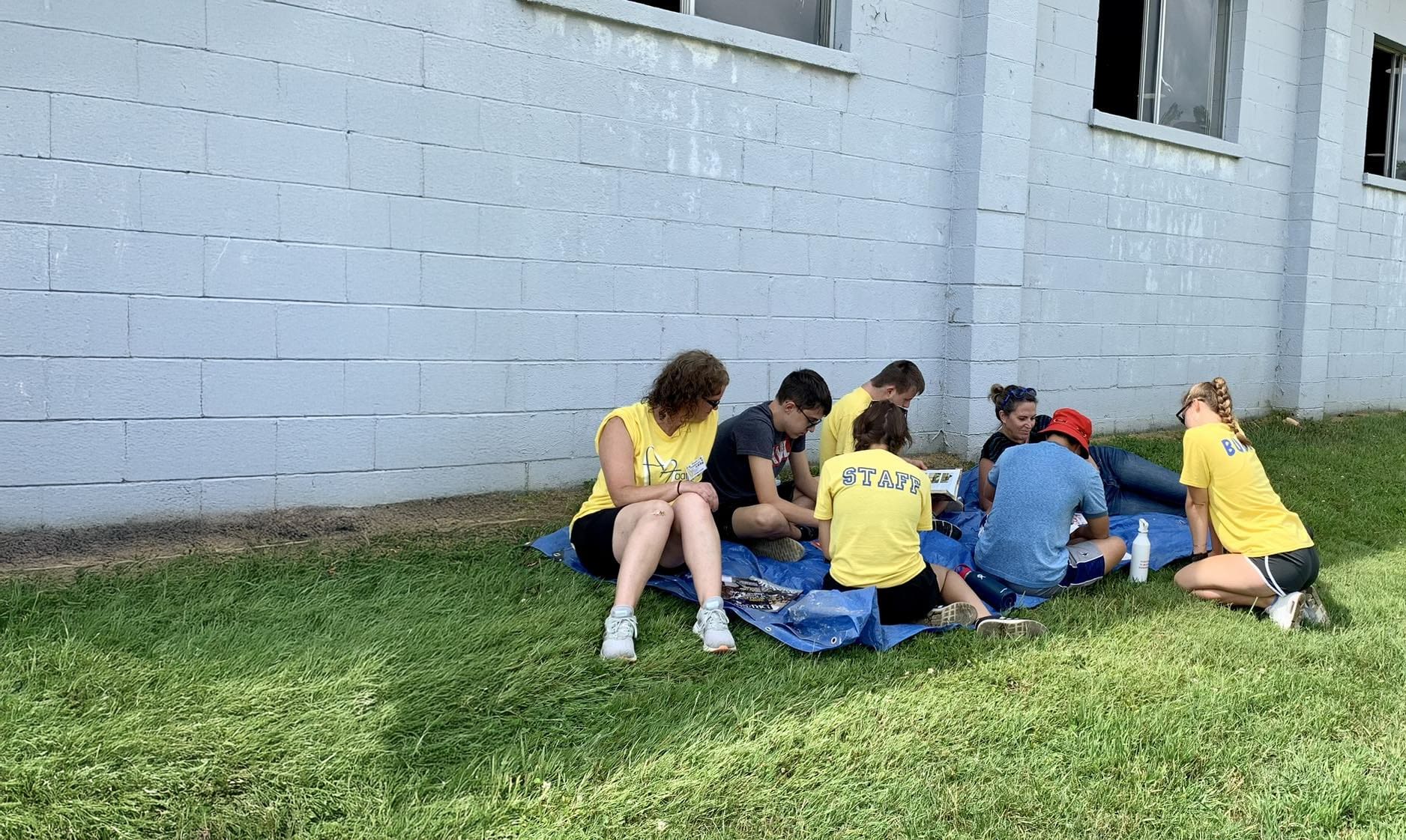 volunteers hanging out against a wall