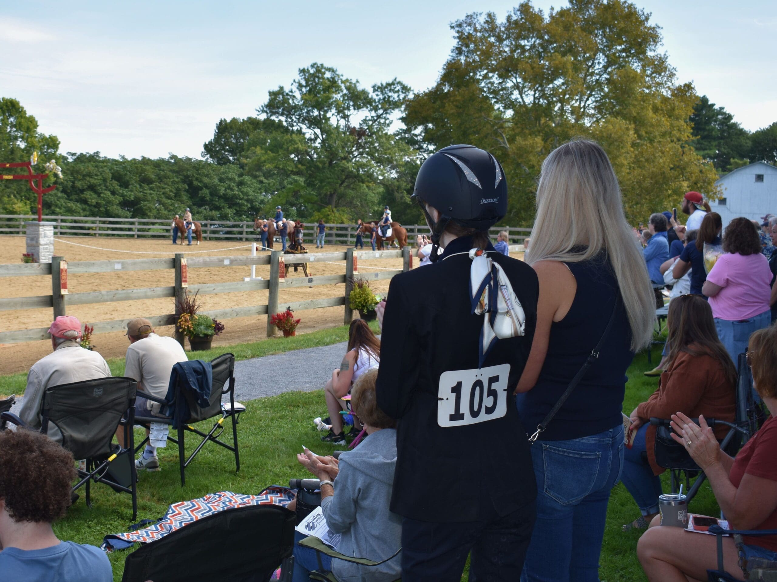 Woman watching a horse how.